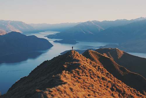 mountain person standing on top of hill nature